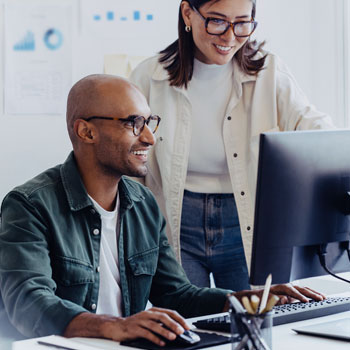 Man and women collaborating on computer