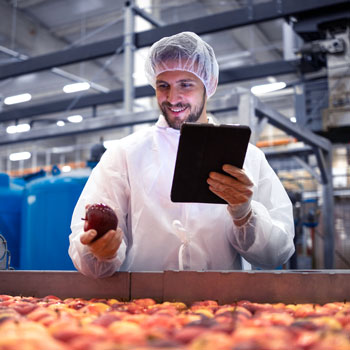 Man working in apple factory on an ipad