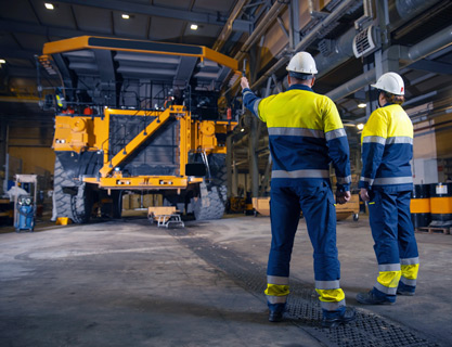 Mining Machine with two men standing in front