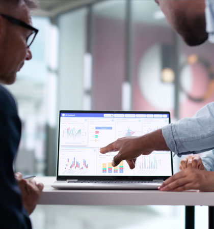 Men looking and pointing at computer screen of data