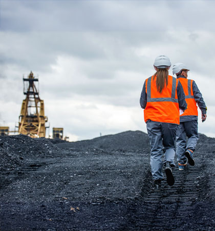 Man and women walking in mining field
