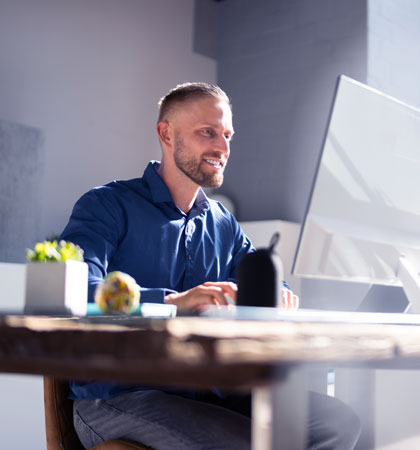 Man working on computer smiling