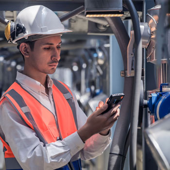 Man working in factory on phone
