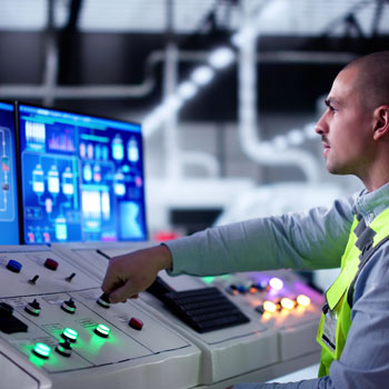 Man working controls in factory