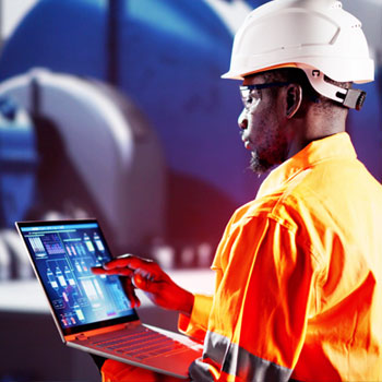 Factory worker working in manufacture on computer