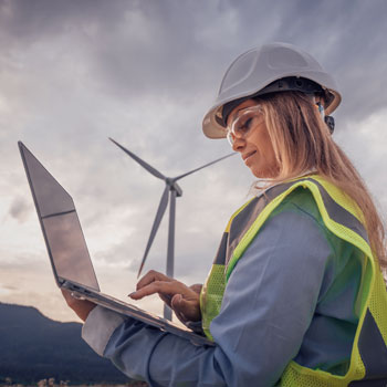 Women working in the windmill field on her computer