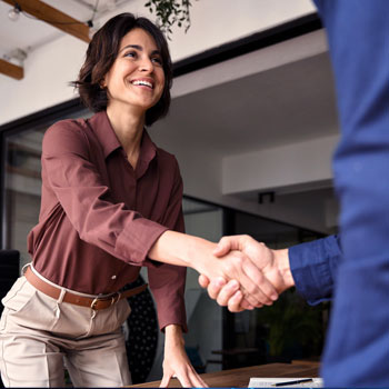 Business women shaking hand with man