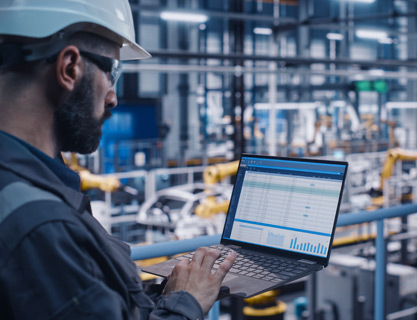 Factory worker on computer