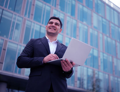 Man working on computer with building