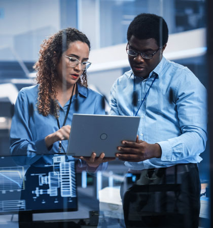 Two coworkers collaborating on computer