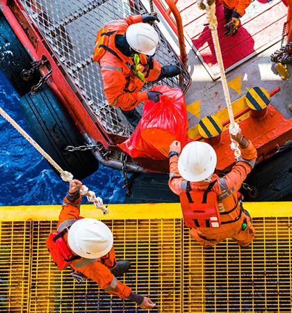 Men working on boat moving bags