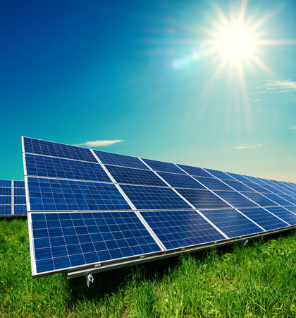 Solar Panels in grass with sun shining